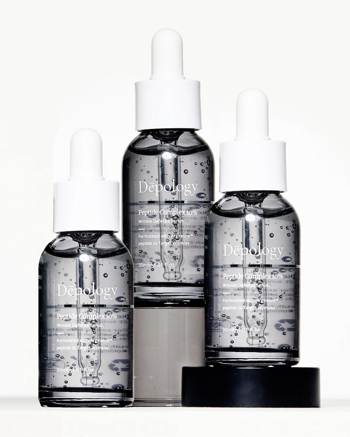 Three bottles of Peptide Complex 10% Serum in varying sizes with dropper caps, displayed against a white background.